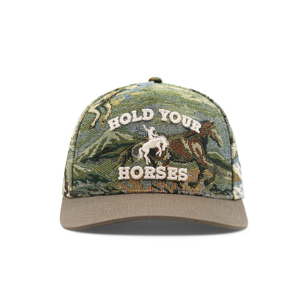 Camouflage cap with 'Hold Your Horses' text and horse graphic on a white background