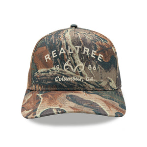 Realtree structured A-frame cap in faded Advantage camo with embroidered 1986 Columbus, GA front logo.
