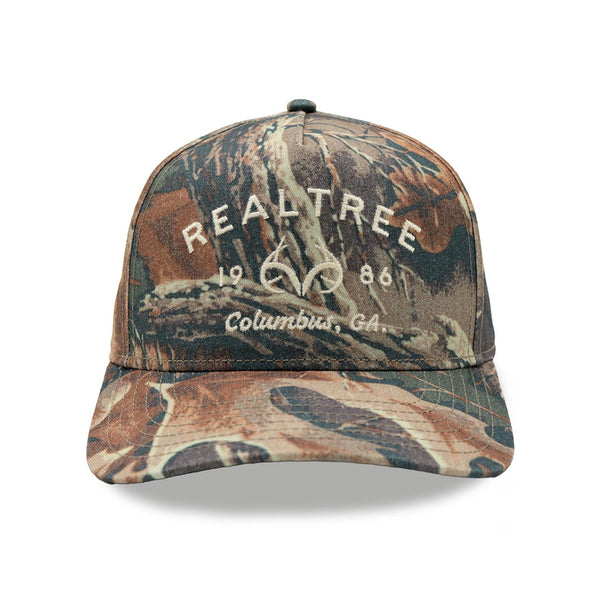 Realtree structured A-frame cap in faded Advantage camo with embroidered 1986 Columbus, GA front logo.
