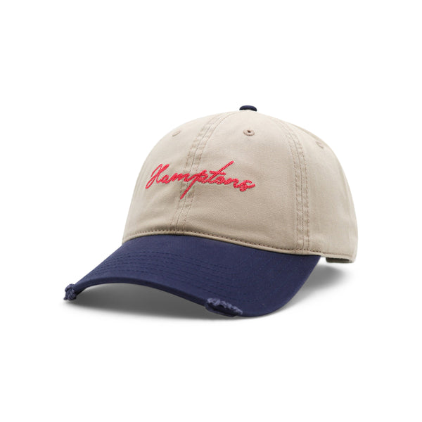 Beige and blue cap with red text on a white background