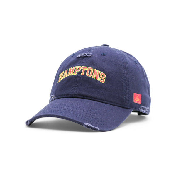Navy blue cap with 'HAMPTONS' text on a white background