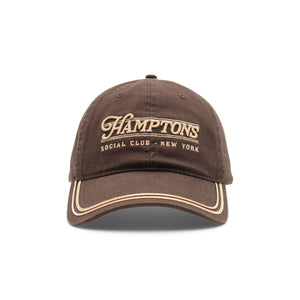 Brown cap with 'Hamptons Social Club New York' text on a white background
